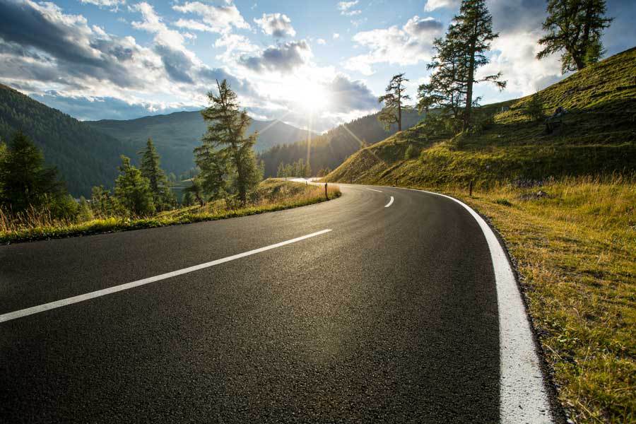 road in hills with sunset